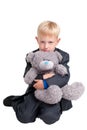 Boy in suit with teddy bear