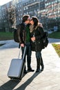 Guy with a suitcase and girl kisses in park Royalty Free Stock Photo