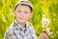 Boy on summer nature with dandelions Royalty Free Stock Photo