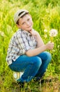 Boy on summer nature with dandelions Royalty Free Stock Photo