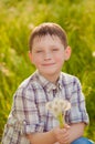 Boy on summer nature with dandelions Royalty Free Stock Photo