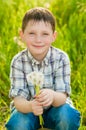 Boy on summer nature with dandelions Royalty Free Stock Photo