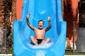 Boy in summer on vacation, has fun, on water slides Royalty Free Stock Photo