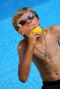 Boy with sun glasses eating an apple Royalty Free Stock Photo