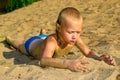 Boy sunbathes on the sand Royalty Free Stock Photo