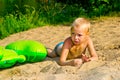 Boy sunbathes on the sand Royalty Free Stock Photo