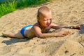 Boy sunbathes on the sand Royalty Free Stock Photo