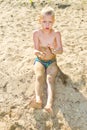 Boy sunbathes on the sand Royalty Free Stock Photo