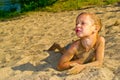 Boy sunbathes on the sand Royalty Free Stock Photo