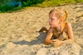 Boy sunbathes on the sand Royalty Free Stock Photo