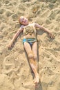 Boy sunbathes on the sand Royalty Free Stock Photo