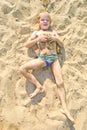Boy sunbathes on the sand Royalty Free Stock Photo