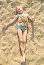 Boy sunbathes on the sand Royalty Free Stock Photo