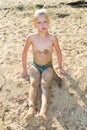 Boy sunbathes on the sand Royalty Free Stock Photo