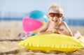 Boy sunbathing on an inflatable mattress Royalty Free Stock Photo