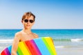 Boy in sunglasses with swim board at the beach Royalty Free Stock Photo