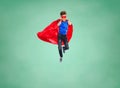 Boy in super hero cape and mask showing thumbs up Royalty Free Stock Photo