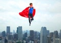 Boy in super hero cape and mask showing thumbs up Royalty Free Stock Photo