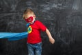 Boy superhero in a blue Cape red mask and a red t-shirt with a star