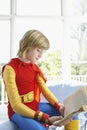 Boy In Superman Costume Reading