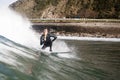 Boy surfing while eating an ice cream cone with several balls of different flavors