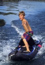 Boy Surfs Kayak - Boat Tow Royalty Free Stock Photo