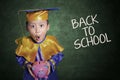 Boy surprise holding piggybank in class Royalty Free Stock Photo