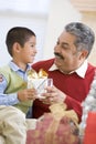 Boy Surprising Father With Christmas Present Royalty Free Stock Photo