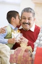 Boy Surprising Father With Christmas Present Royalty Free Stock Photo