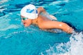 Boy swimming butterfly stoke.