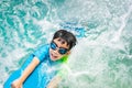 A boy is swimming with kickboard and swimming goggles Royalty Free Stock Photo