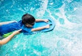 A boy is swimming with kickboard and swimming goggles Royalty Free Stock Photo