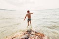 Boy swimming in lake with underwater goggles. Child diving in water with large splash waves. Royalty Free Stock Photo