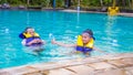 Boy swimming with life vest and googles on poking out his tongue looking very happy Royalty Free Stock Photo