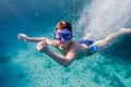 Boy in swimming mask deep dive in Red sea near coral reef