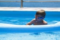 boy is swimming on a mattress in the pool in the Villa Royalty Free Stock Photo