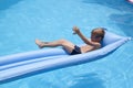 boy is swimming on a mattress in the pool in the Villa Royalty Free Stock Photo