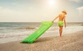 Boy with swimming mattress walks on sand sea beach Royalty Free Stock Photo