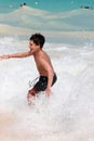 Boy swimming in ocean waves Royalty Free Stock Photo