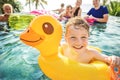 Boy swimming in a pool with family Royalty Free Stock Photo