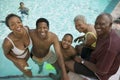 Boy (7-9) at swimming pool with parents and grandparents elevated view portrait. Royalty Free Stock Photo