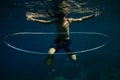 Boy swimming underwater near air ring