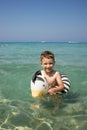 A boy swims, a child with an inflatable lifebuoy in the shape of a zebra. Summer swim. Bathing a child in water. Active