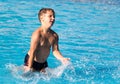 Boy swims with a splash in the water park Royalty Free Stock Photo