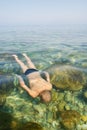 Boy swims under water in sea