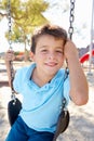 Boy On Swing In Park Royalty Free Stock Photo