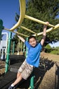 Boy Swinging on Jungle gym - Vertical Royalty Free Stock Photo