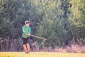 Boy Swinging a Large Stick Like a Baseball Bat