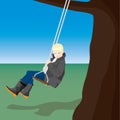 Boy swinging on a rope swing with tree