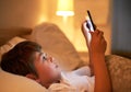 Boy, tablet and bed with night, learning and technology for social media and growth. Child, bedroom and connectivity for Royalty Free Stock Photo